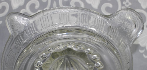 The speckled finish on a Crown Crystal Glass Type 6 clear glass juicer