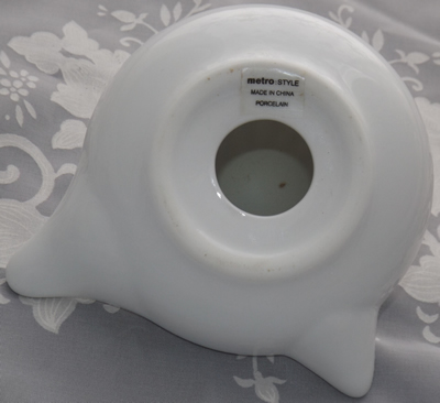 The base of a Metro Style white ceramic juicer with label