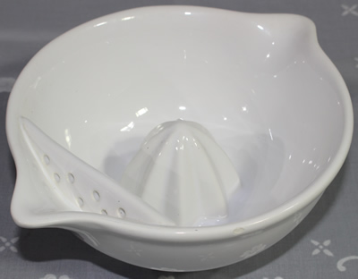 Alternate view of a white double spout strainer ceramic juicer