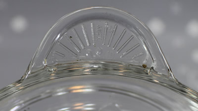 The handle on a Borgonovo Italy clear glass juicer