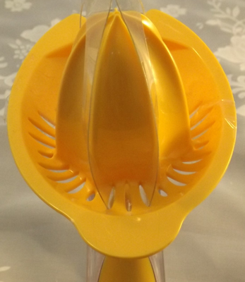 Top view of an orange plastic Progressive Citrus Juicer with Measure