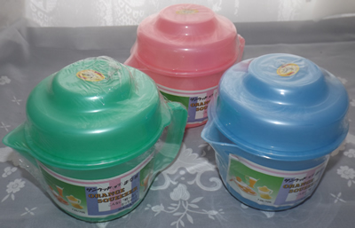 3 colours of a  plastic juicer on jug with lid