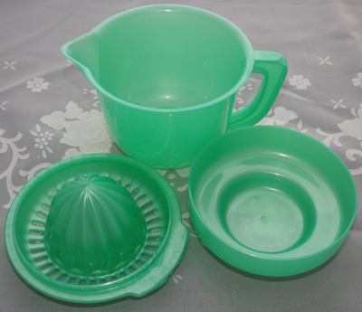 3 parts of  Green plastic juicer on jug with lid