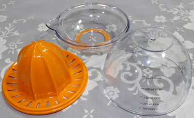 The 3 parts of an orange Progressive 3 piece plastic juicer