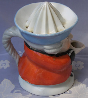 Right view of an orange with blue hat black collar1 piece toby juicer