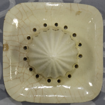 Top view of a 'square' cream ceramic reamer