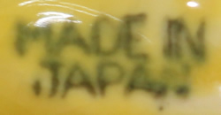 Yellow, brown and green 1 piece loop handle juicer