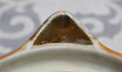Showing the gold spout on an orange pear shape juicer