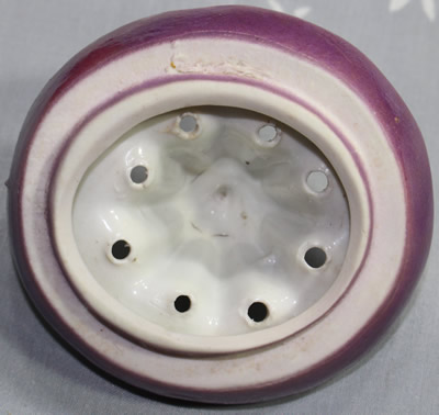 Showing the purple on an orange jug, green leaves and purple top ceramic juicer