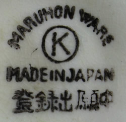 The basemark on a blue leaf saucer shape with clown head juicer
