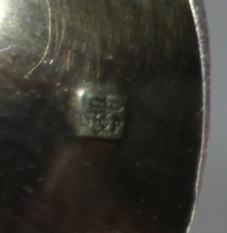 Hallmark on the spoon in a French Christening set with silver trim white juicer