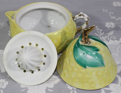 The 3 parts of a hand painted green leaves on pale yellow lustre pear shape juicer