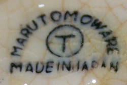 The Marutomo Ware basemark on a cream and green bee juicer