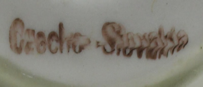 Base mark on orange on white saucer shape juicer