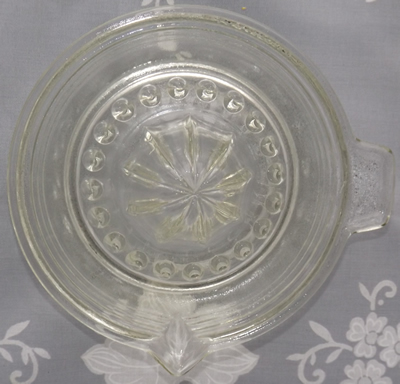 Top view of a stepped 4 concentric circles clear glass juicer