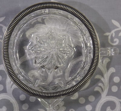Silver rimmed clear glass juicer top view
