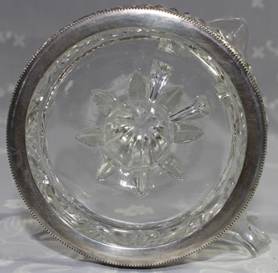 Base of silver rim on base of a French crystal juicer