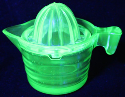 The U.S.Glass Co. Handy Andy Green glass juicer under UV light