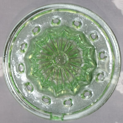 The reamer for a large green glass jug juicer with lid