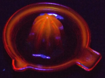 Red glow Edna Barnes 2¼" juicer under UV light