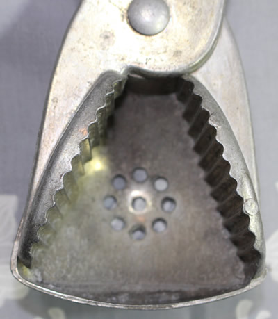 The drain holes on a Taiwanese aluminium wedge juicer