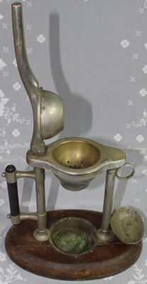 An open chrome plated mechanical lever squeezer juicer