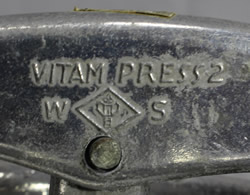 The embossing on an aluminium Vitam Press 2 squeeze juicer