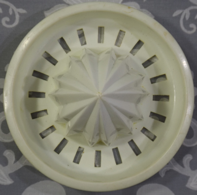 Reamer for a yellow-orange and white plastic juicer