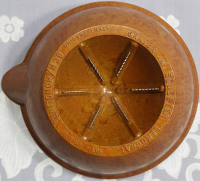 The base showing the marks and the zester on a mottled brown BCM Monolines bakelite juicer