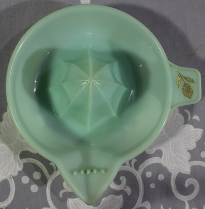 Embossed brand on a translucent pale blue plastic Associated Plastics juicer