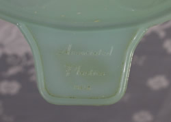 Embossed brand on a translucent pale blue plastic Associated Plastics juicer