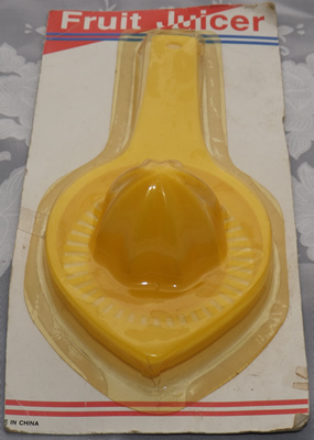Old "new stock" yellow hand held juicer in original packaging