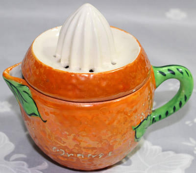 'ORANGE' on peel texture orange juicer with green leaves