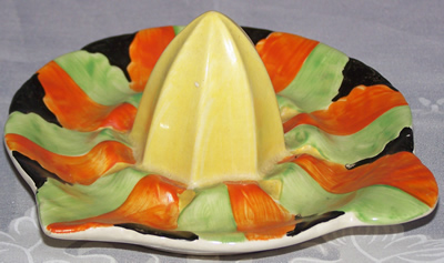 Yellow, orange, black and green saucer juicer