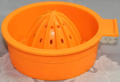 2 piece orange and translucent white plastic juicer