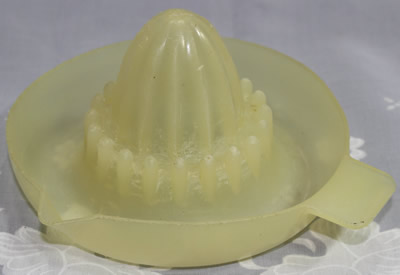 A translucent cream colour British Plastics Pty. Ltd. saucer juicer